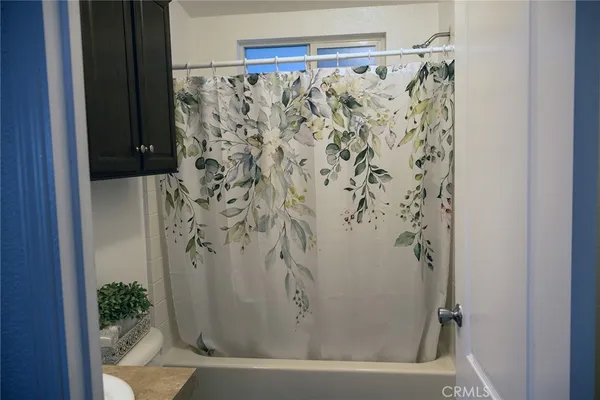 a bathroom with a bathtub and shower