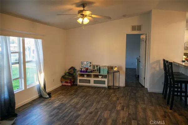 a view of a workspace with furniture and a window