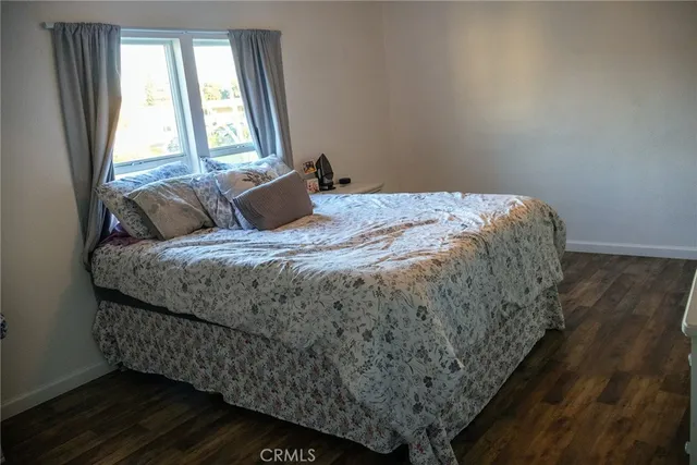 a bed sitting in a bedroom next to a window