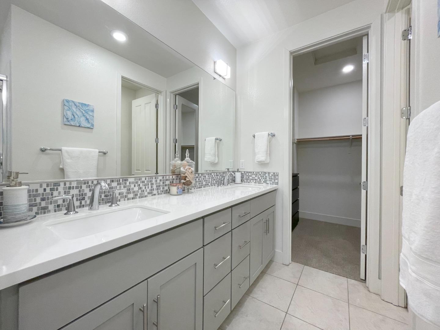 716 Amalfi Loop Milpitas, CA 95035 - Photo 16 of 28 a bathroom with a sink and a mirror