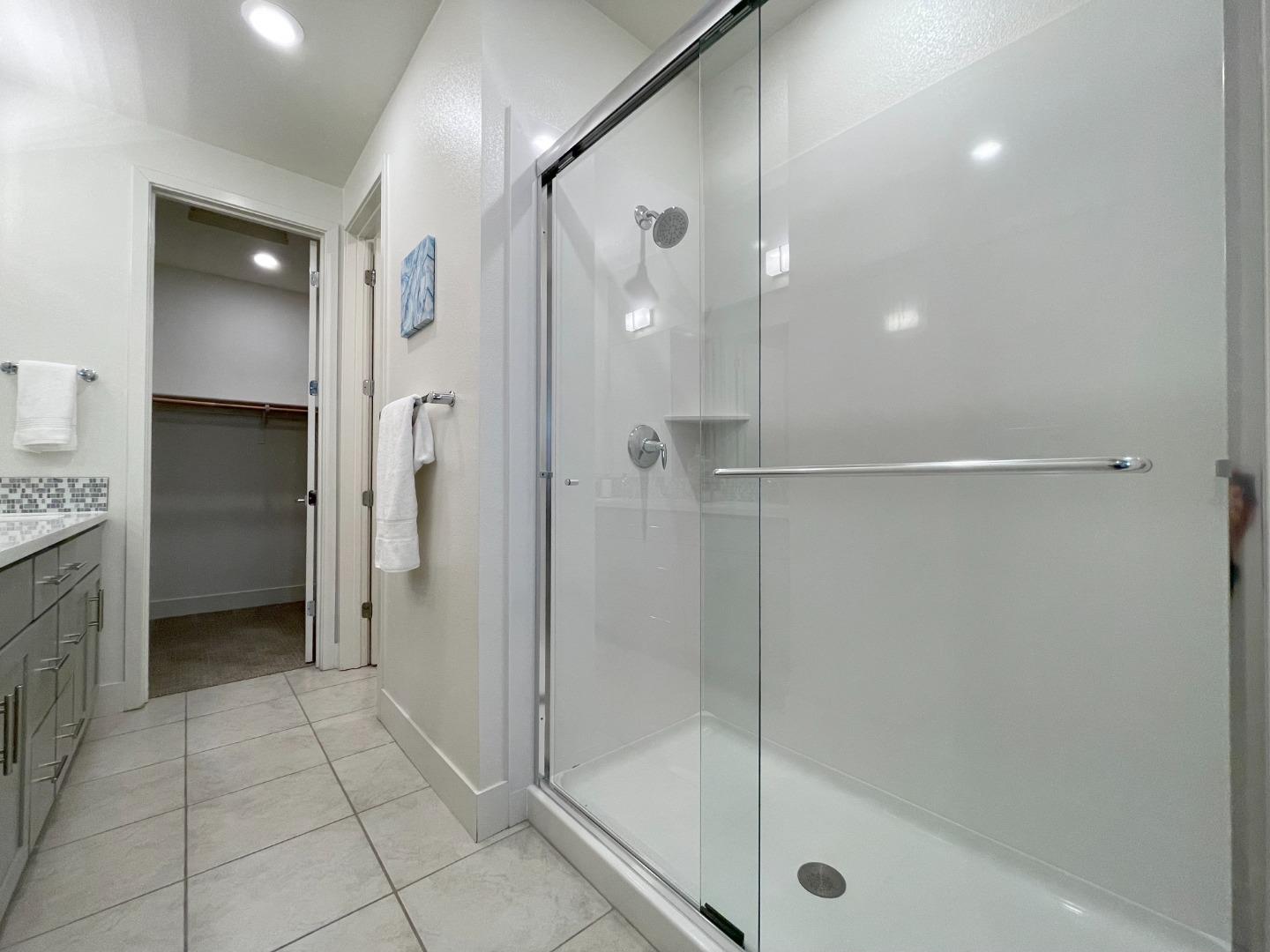 716 Amalfi Loop Milpitas, CA 95035 - Photo 17 of 28 a bathroom with a shower and a glass door