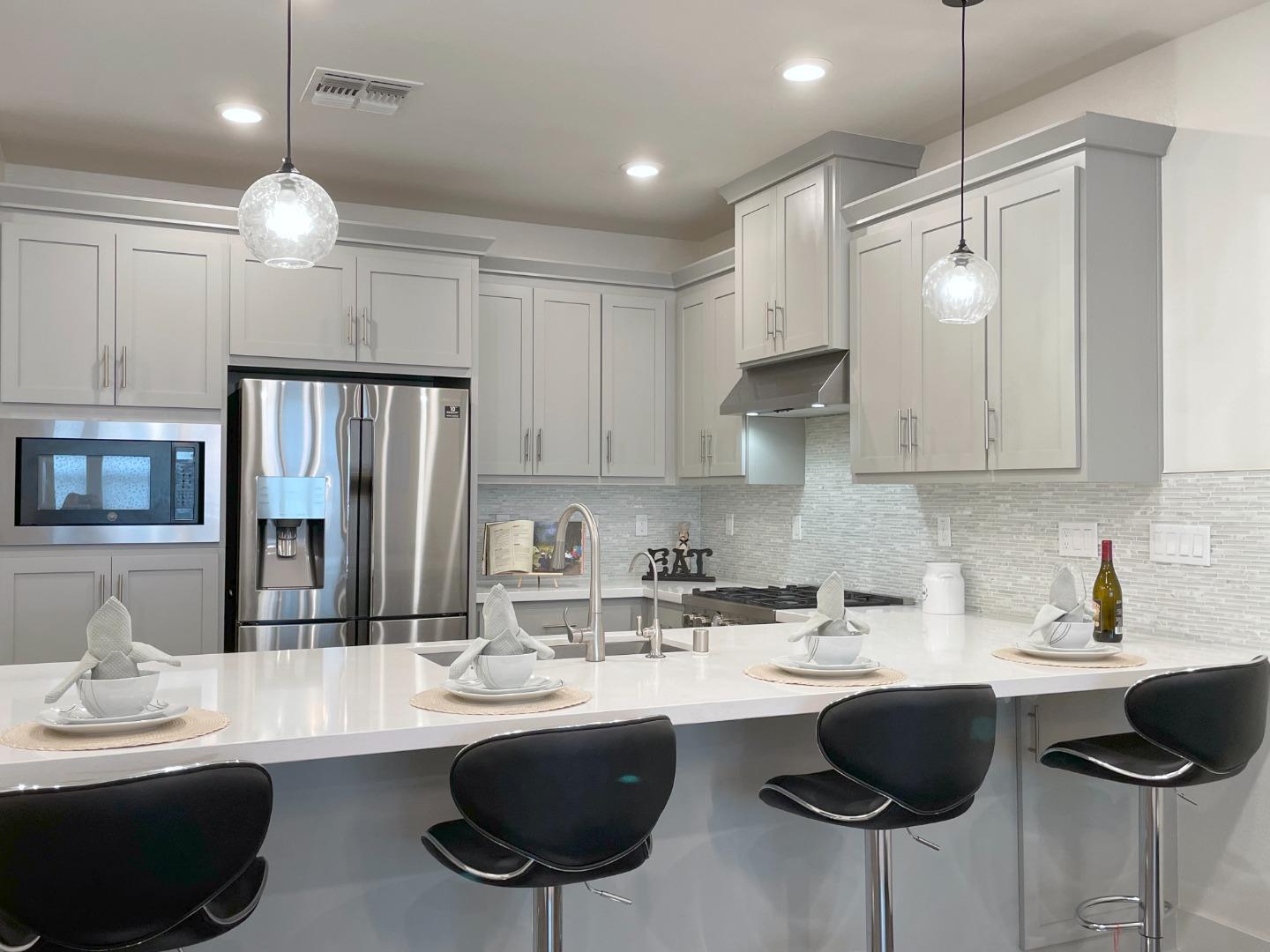 716 Amalfi Loop Milpitas, CA 95035 - Photo 4 of 28 a kitchen with cabinets a sink and appliances