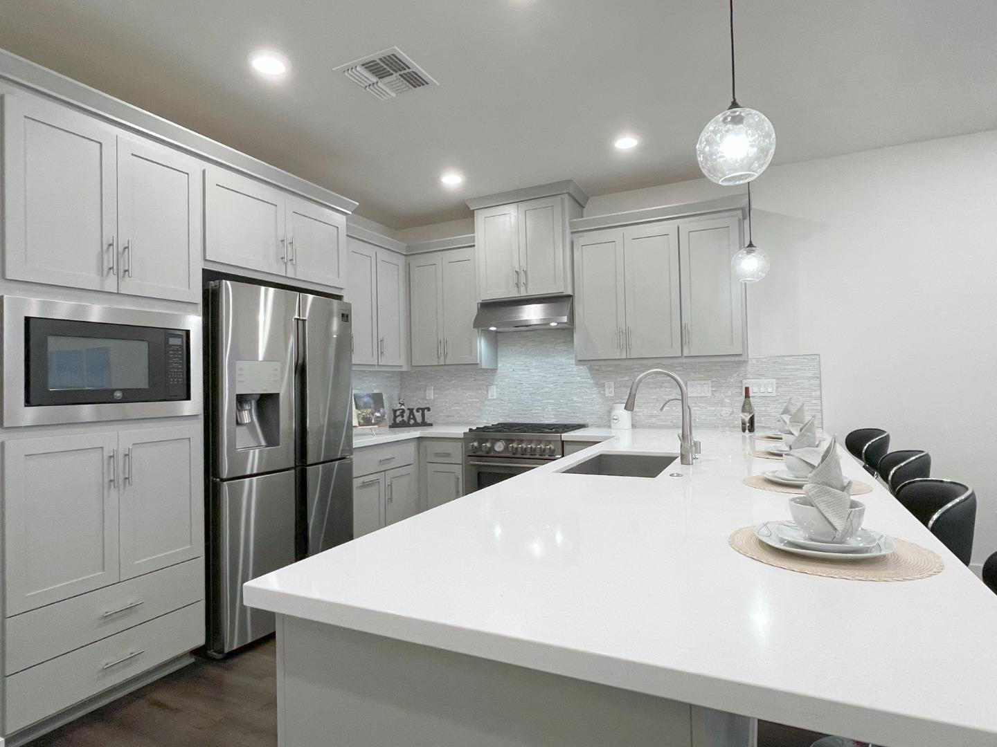 716 Amalfi Loop Milpitas, CA 95035 - Photo 6 of 28 a kitchen with refrigerator a sink and cabinets