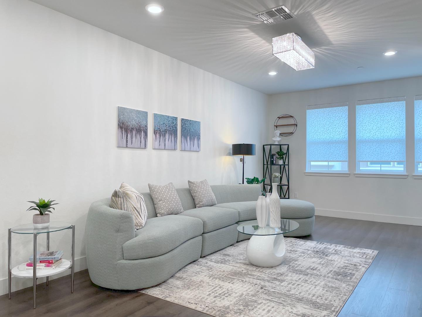 716 Amalfi Loop Milpitas, CA 95035 - Photo 7 of 28 a living room with furniture and a chandelier