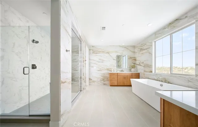 a kitchen with stainless steel appliances kitchen island granite countertop a stove a sink and a refrigerator