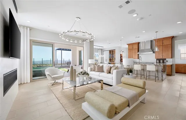 a living room with furniture and large windows