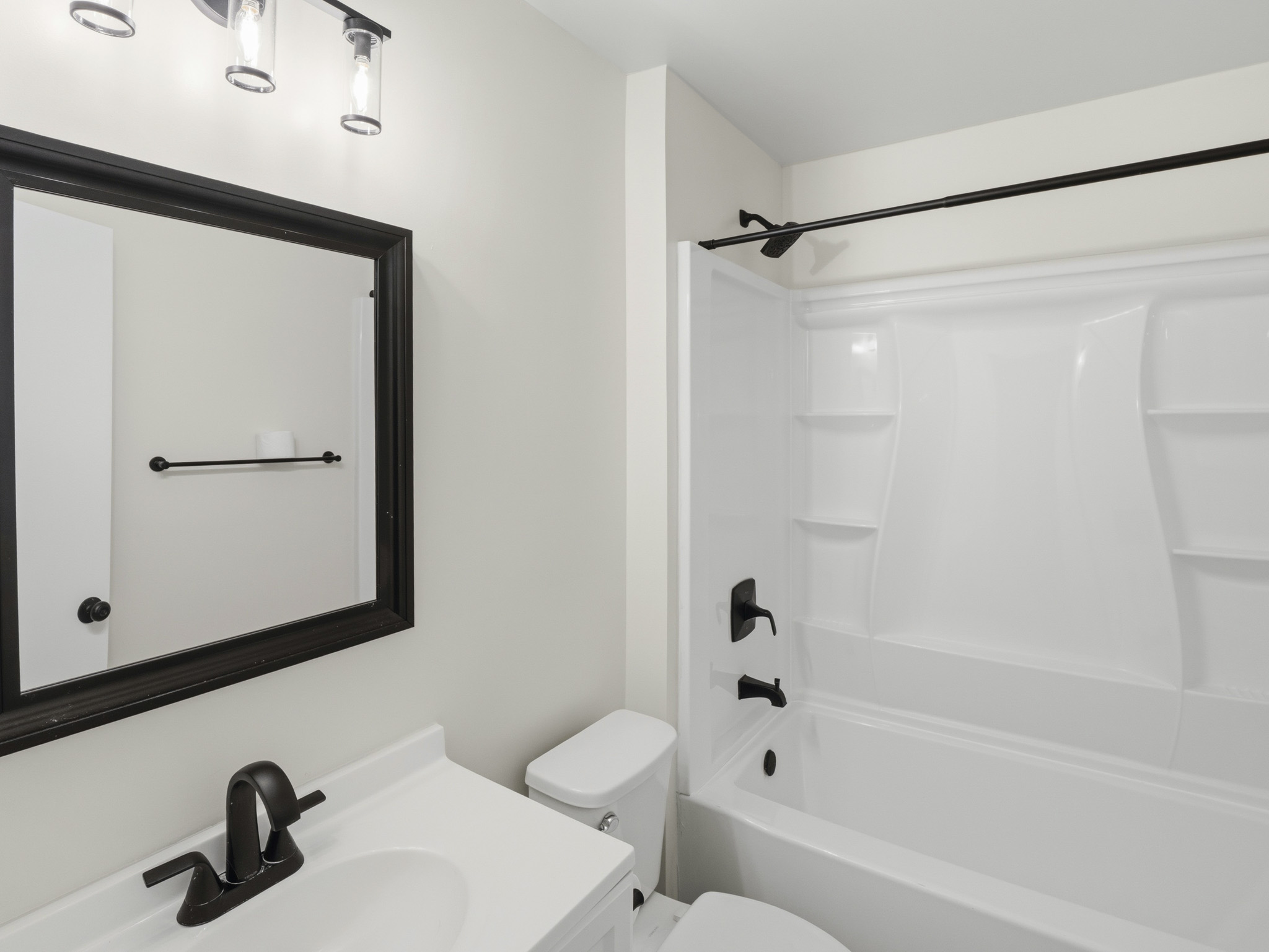2401 Burleson Road Austin, TX 78741 - Photo 13 of 25 A well-appointed bathroom with a sleek vanity and a pristine tub-shower combination awaits.