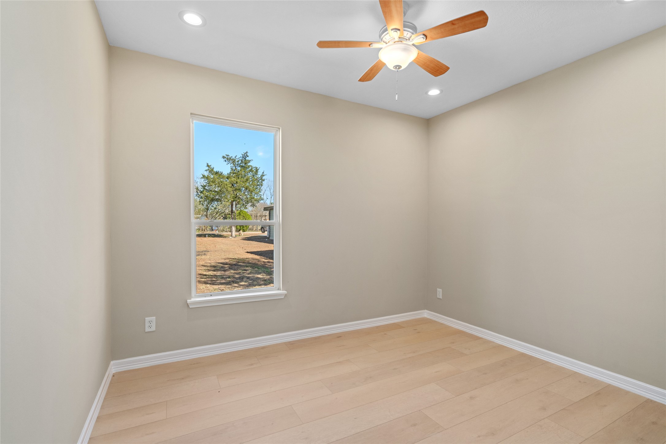 4654 North Teague Street Rosharon, TX 77583 - Photo 35 of 46 Cozy bedroom bathed in natural light with soft neutral walls and hardwood floors—ready for your personal touch.
