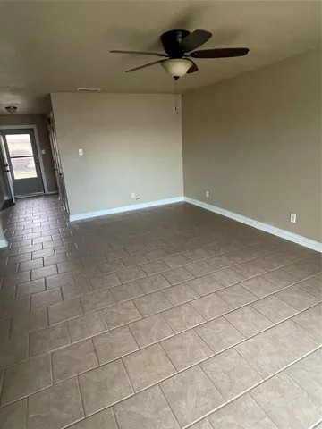 a view of an empty room and a window