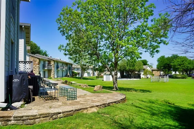 a view of a house with yard and a tree