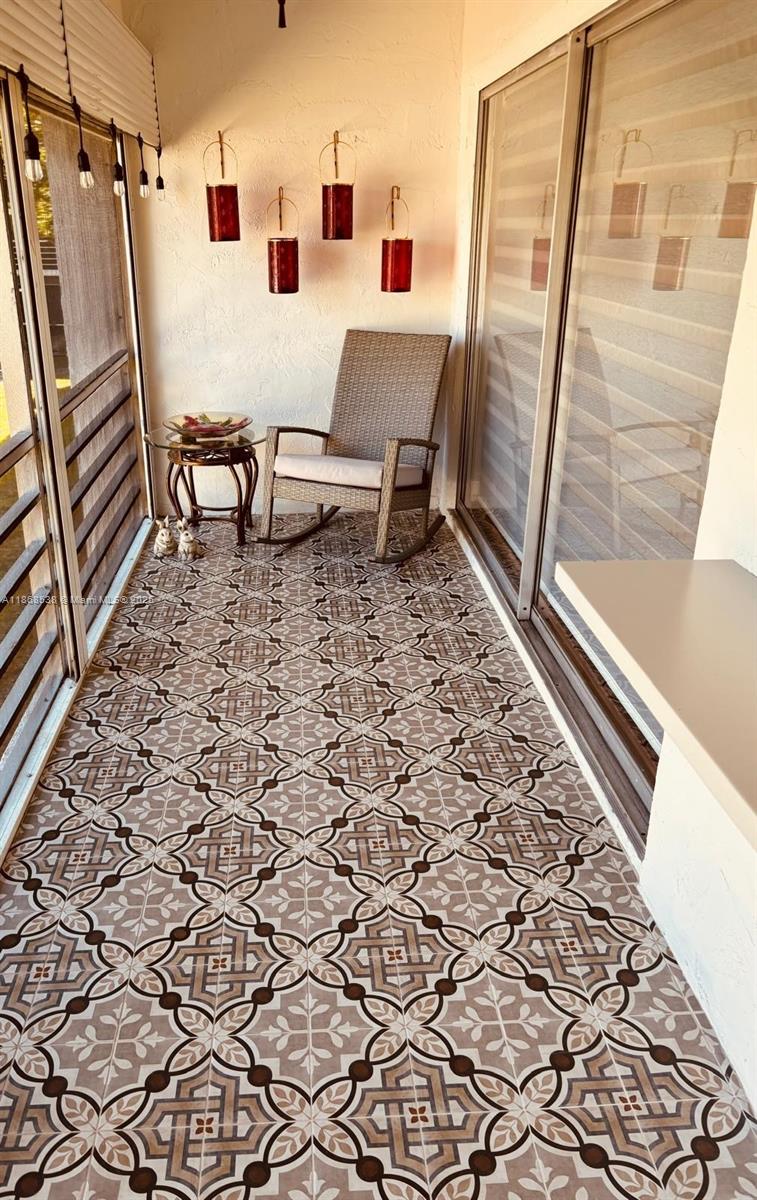 3501 Inverrary Drive, Unit 201 Lauderhill, FL 33319 - Photo 24 of 35 a living room with a couch and a rug