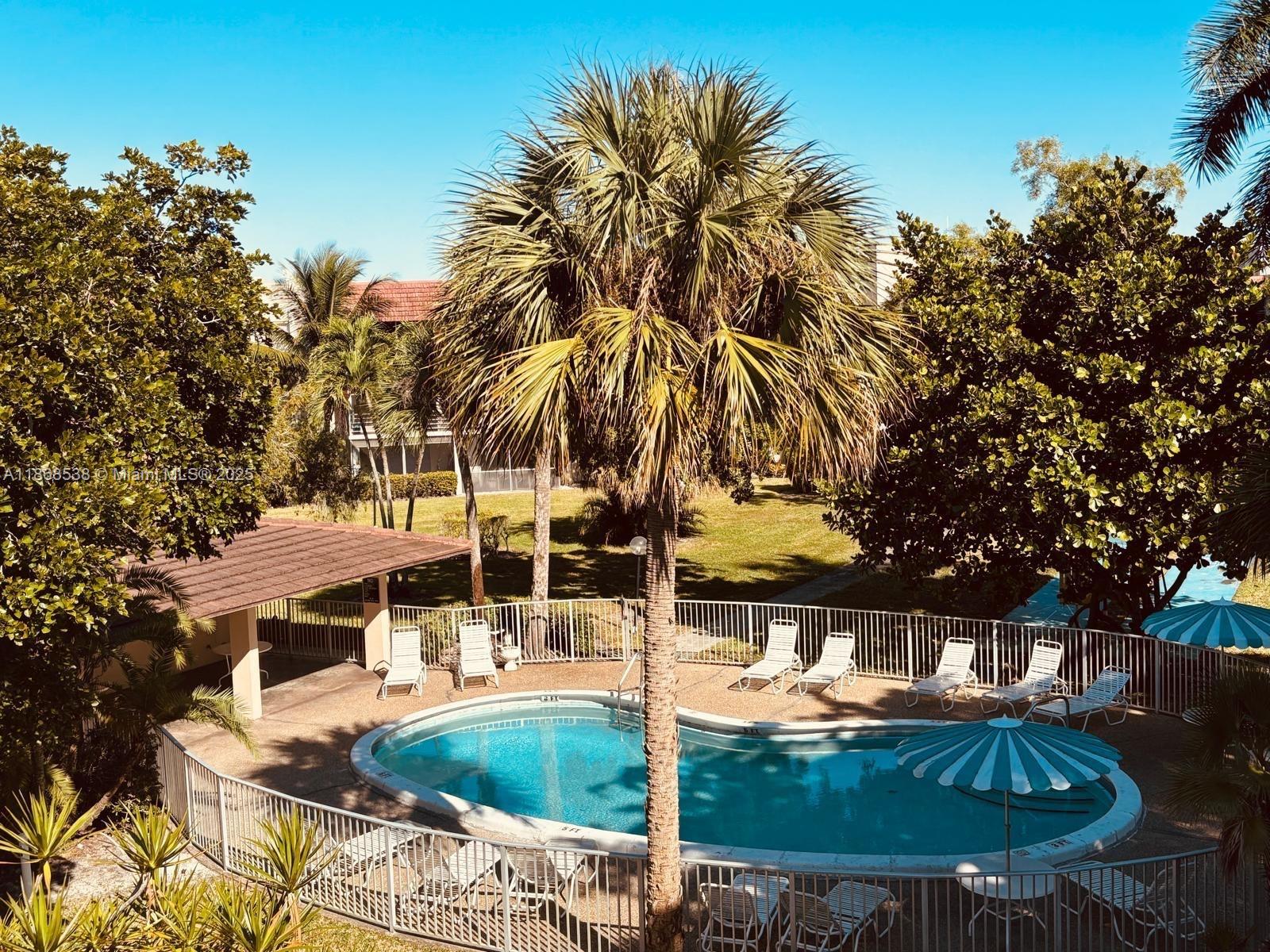 3501 Inverrary Drive, Unit 201 Lauderhill, FL 33319 - Photo 30 of 35 a swimming pool with outdoor seating and yard