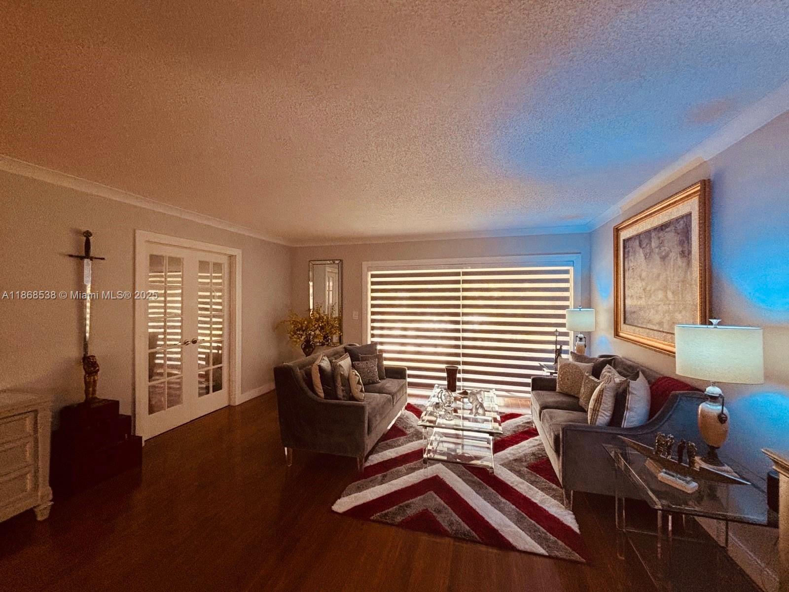 3501 Inverrary Drive, Unit 201 Lauderhill, FL 33319 - Photo 10 of 35 a bedroom with furniture and wooden floor