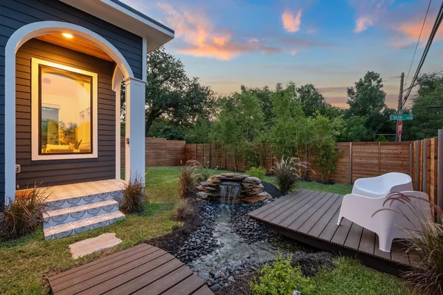 a view of backyard with deck and seating space