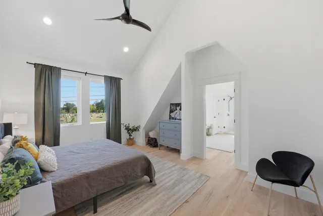 a bedroom with a bed and a chair