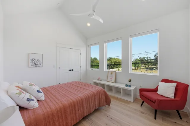 a bedroom with a bed and a window