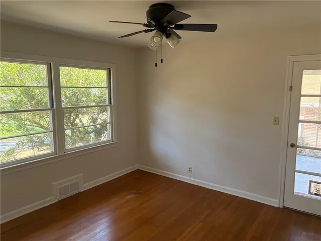 wooden floor in an empty room with a window