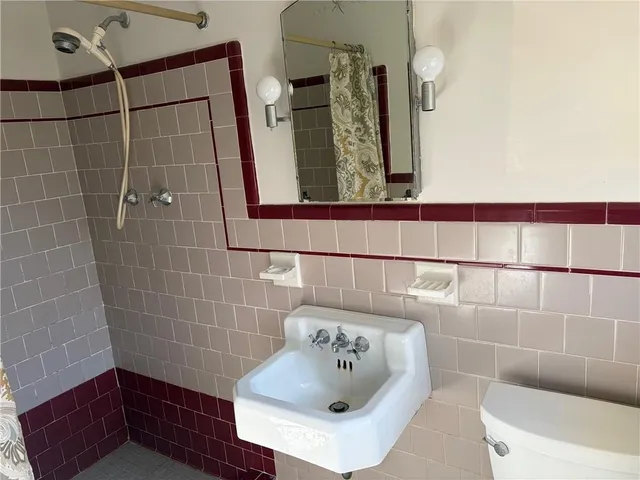 a bathroom with a toilet sink and shower