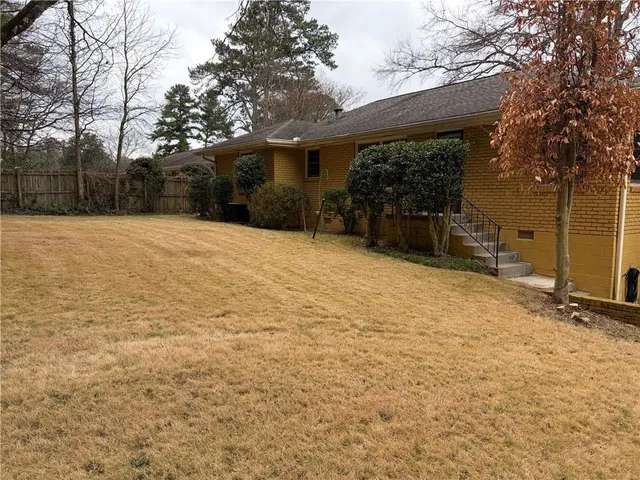 a view of a house with a yard and garage