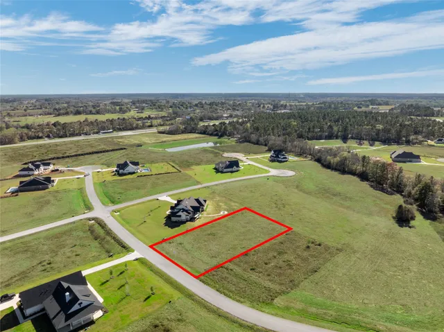 a view of a pool with lawn chairs and couches