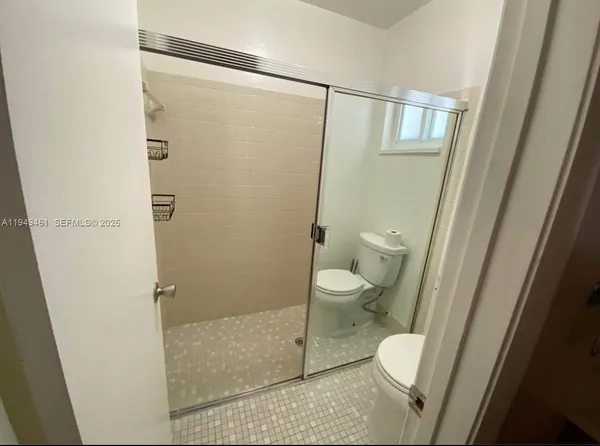 a bathroom with a toilet and a shower