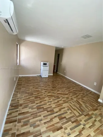 a view of a room with wooden floor and chair