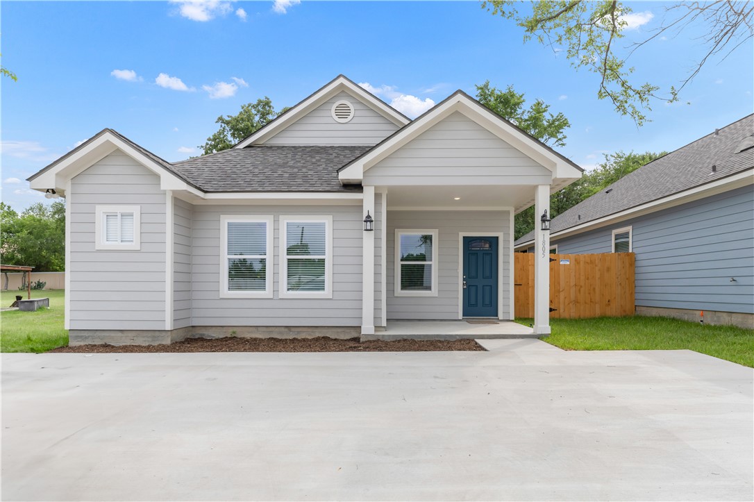 a front view of a house with a garden and yard