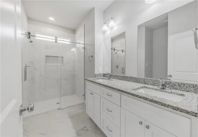 a bathroom with a granite countertop sink mirror and double