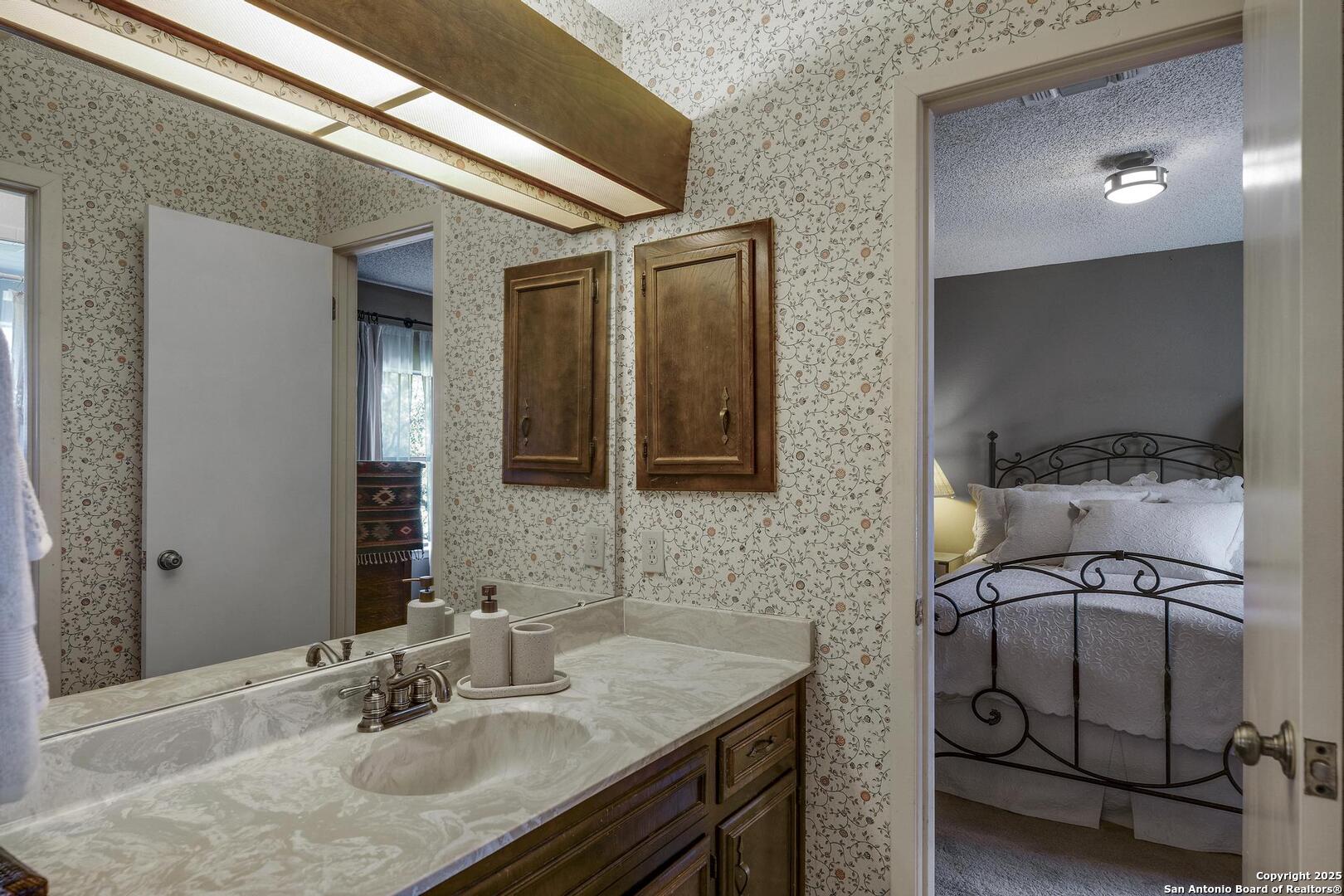 127 Siebeneicher Road Boerne, TX 78006 - Photo 26 of 50 a bathroom with a sink and a mirror