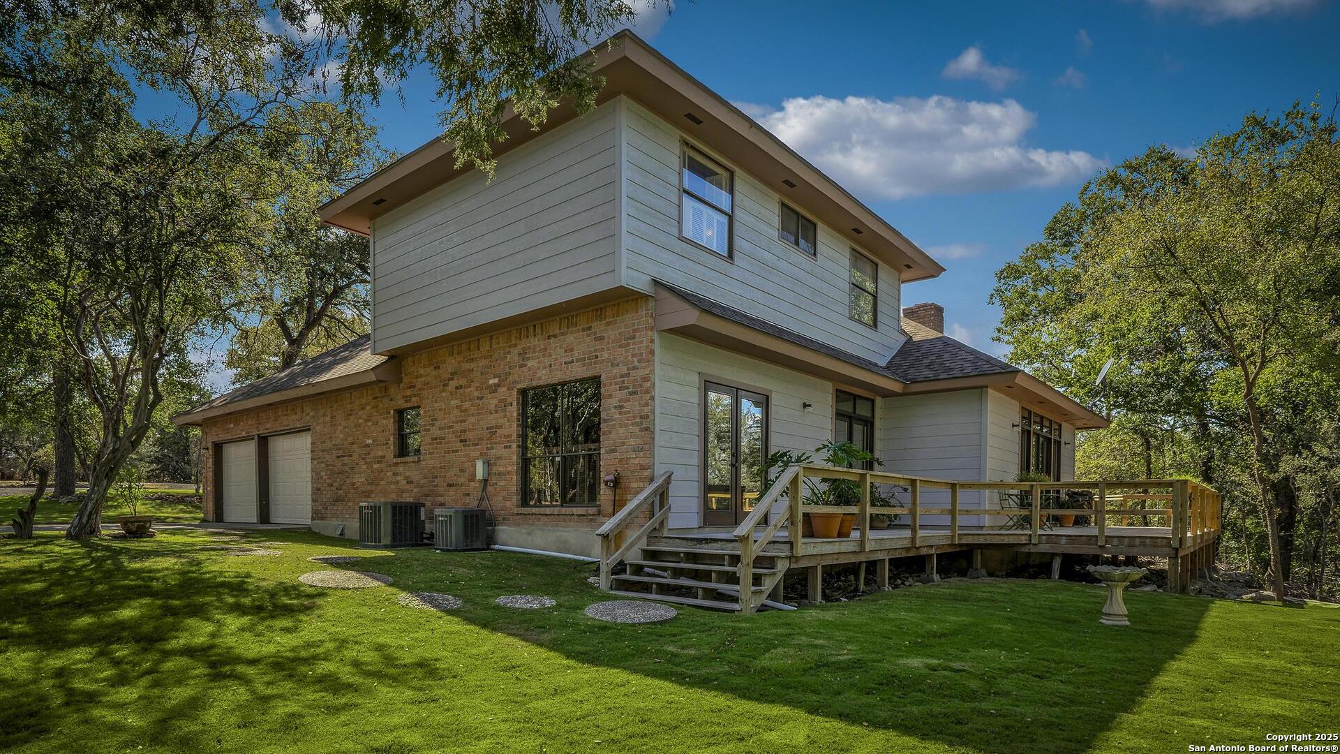 127 Siebeneicher Road Boerne, TX 78006 - Photo 30 of 50 a front view of a house with a yard table and chairs