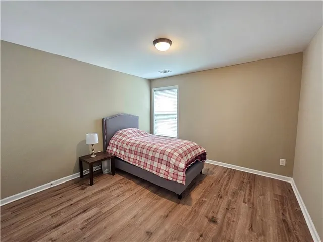 a bedroom with a bed and a desk