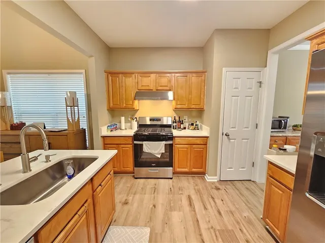 a kitchen with a sink stove and refrigerator