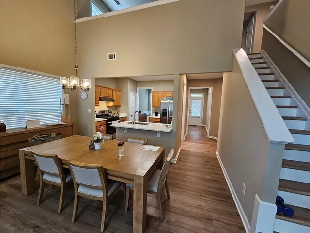 a dining room with furniture and wooden floor