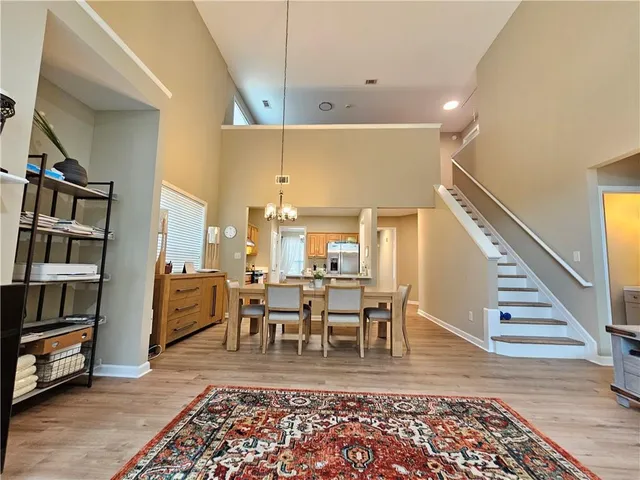 a living room with furniture lamps and wooden floor
