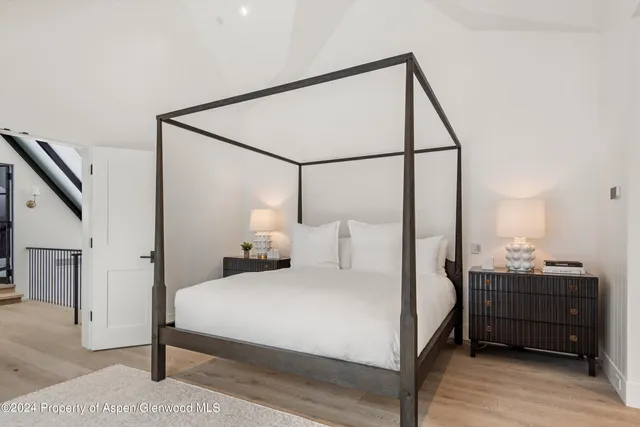 a bedroom with a bed and a mirror