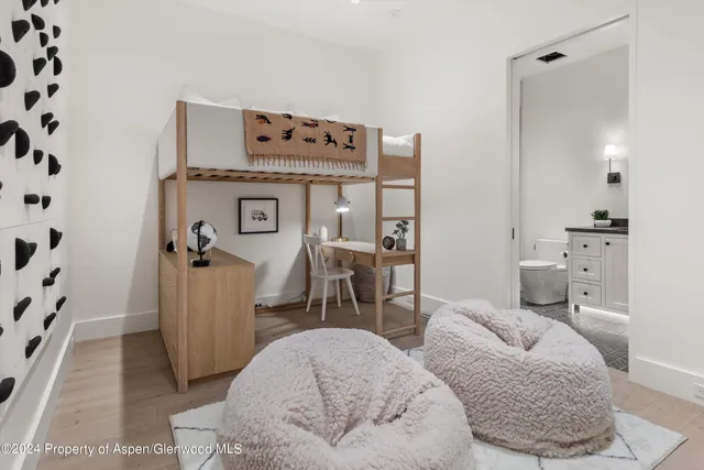 a bathroom with a granite countertop toilet sink and mirror