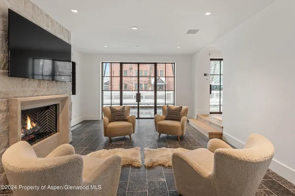 a living room with furniture fireplace and flat screen tv