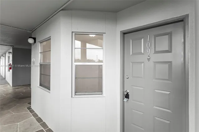 a kitchen with stainless steel appliances granite countertop a refrigerator stove and white cabinets