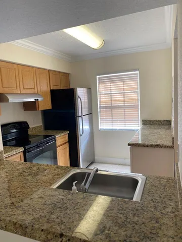 a kitchen with a refrigerator and a sink