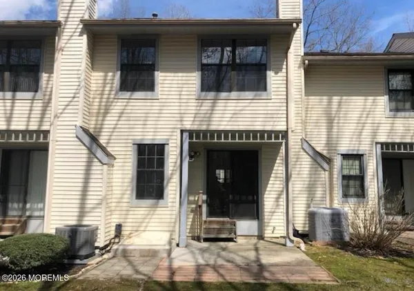 a view of a house with wooden door and outdoor space