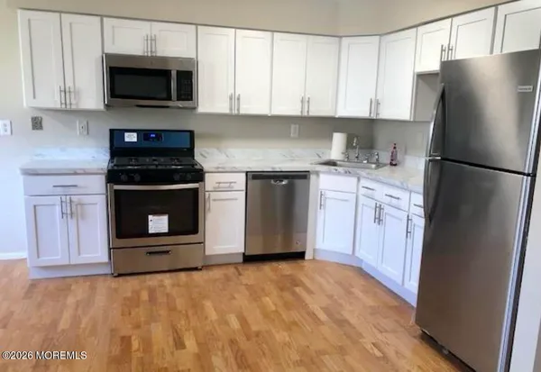 a kitchen with a stove and a refrigerator