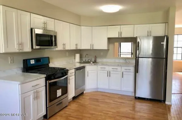 a kitchen with a sink stove and refrigerator