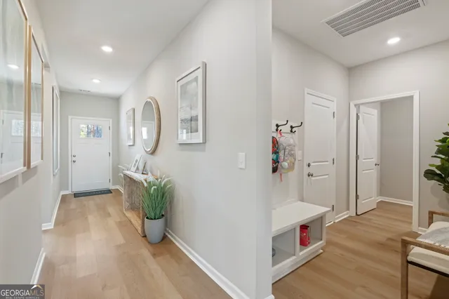 wooden floor with white walls and stairs