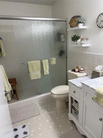 a bathroom with a sink a toilet and vanity