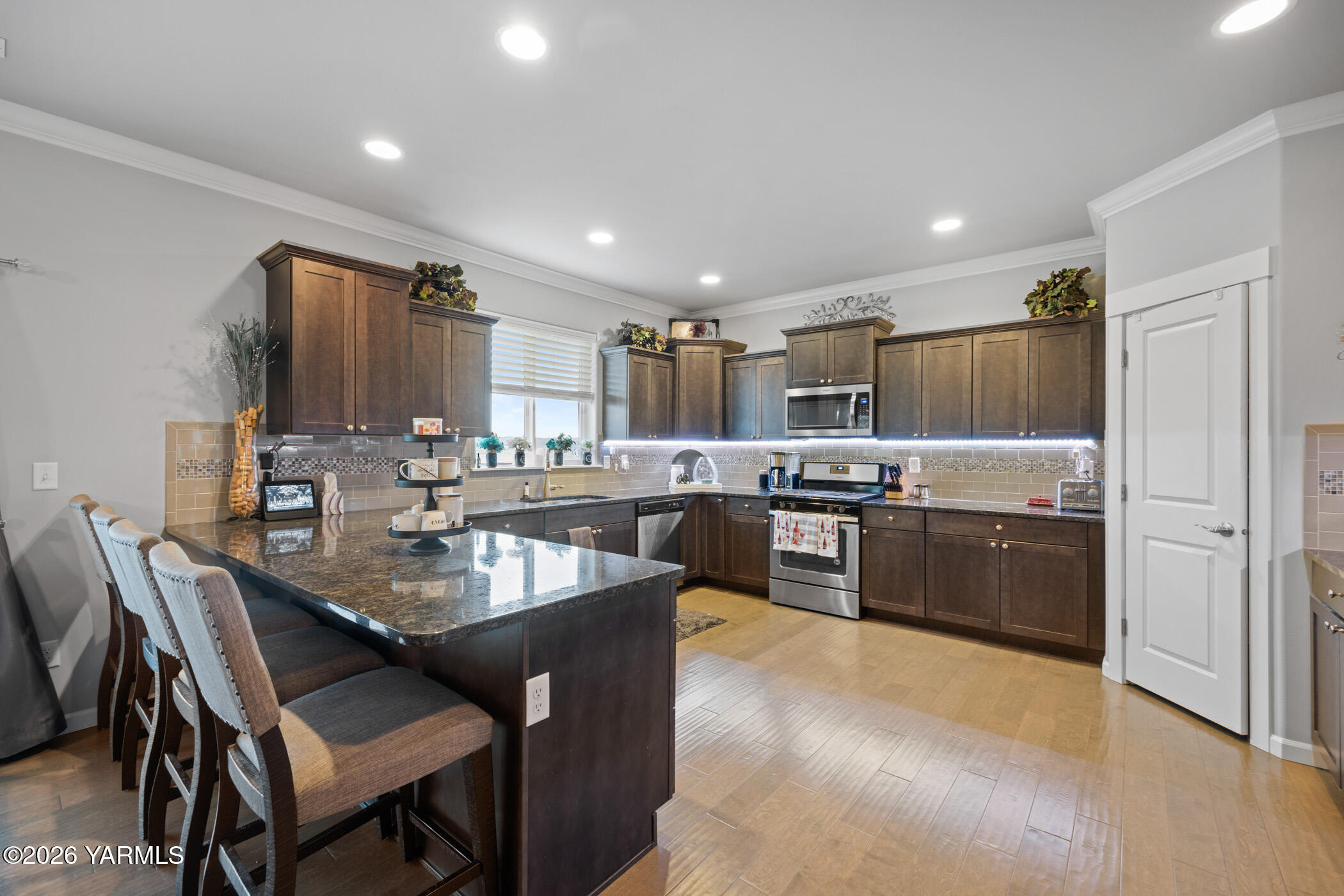 1425 Valhalla Loop Selah, WA 98942 - Photo 17 of 33 a kitchen with kitchen island granite countertop lots of counter top space and stainless steel appliances