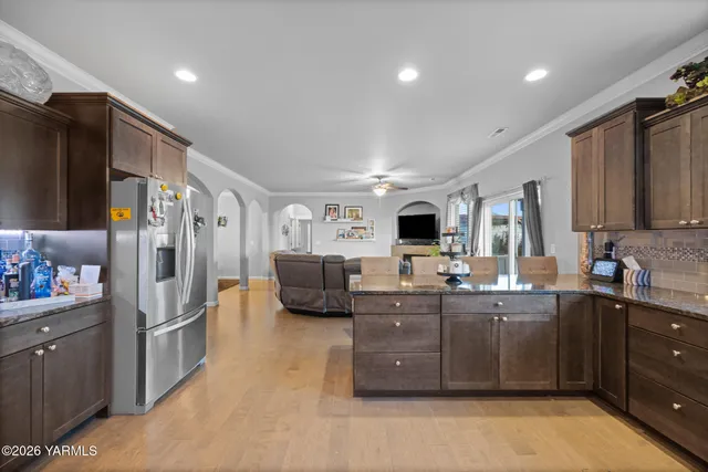 a large kitchen with stainless steel appliances lots of counter top space