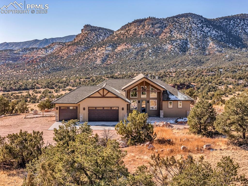 228 Freek Ranch Road Canon City, CO 81212 - Photo 2 of 50 a front view of a house with a yard and mountain view in back