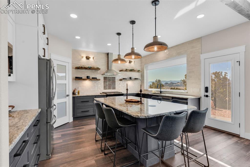 228 Freek Ranch Road Canon City, CO 81212 - Photo 21 of 50 a kitchen with stainless steel appliances a dining table chairs stove refrigerator and cabinets