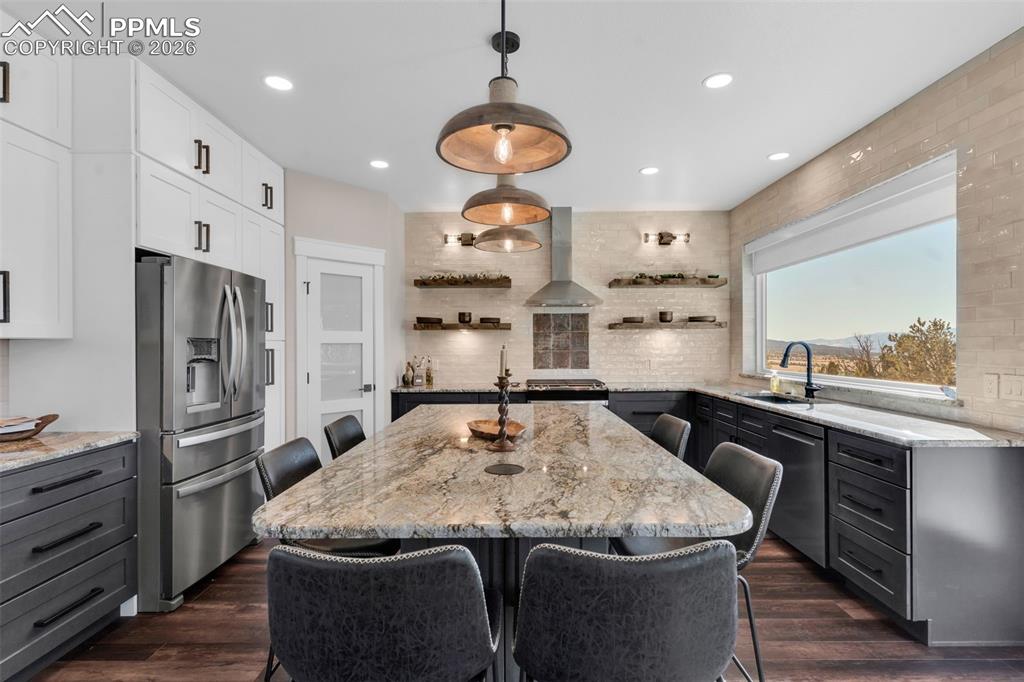 228 Freek Ranch Road Canon City, CO 81212 - Photo 22 of 50 a kitchen with stainless steel appliances granite countertop a sink a refrigerator and a stove