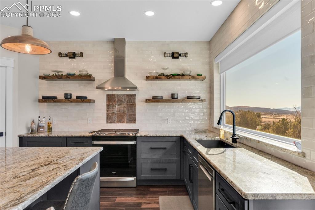228 Freek Ranch Road Canon City, CO 81212 - Photo 24 of 50 a kitchen with stainless steel appliances granite countertop a sink stove and cabinets
